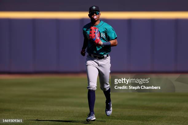 Julio Rodriguez of the Seattle Mariners blows a bubble during the third inning against the San Diego Padres in a spring training game at Peoria...