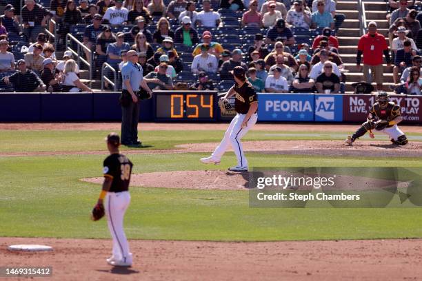 Jay Groome of the San Diego Padres warms up with a pitch clock during the sixth inning] against the Seattle Mariners in a spring training game at...