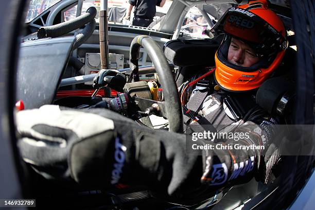 Robby Gordon, driver of the MAPEI/Save Mart Supermarkets Dodge, sits in his car during practice for the NASCAR Sprint Cup Series Toyota/Save Mart 350...