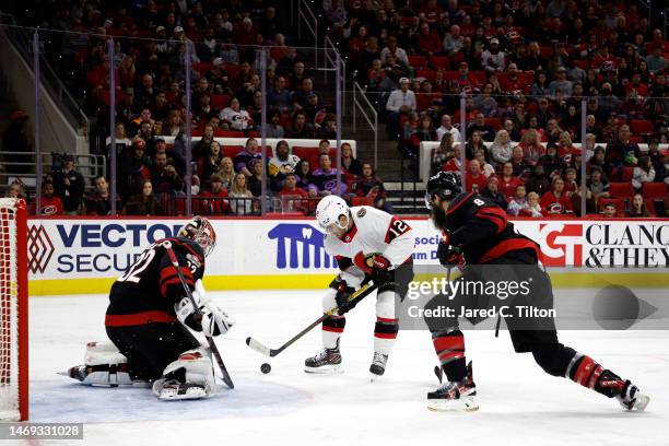 Antti Raanta of the Carolina Hurricanes makes a save against Alex DeBrincat of the Ottawa Senators during the second period of the game at PNC Arena...