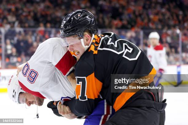 Alex Belzile of the Montreal Canadiens and Wade Allison of the Philadelphia Flyers fight during the second period at Wells Fargo Center on February...