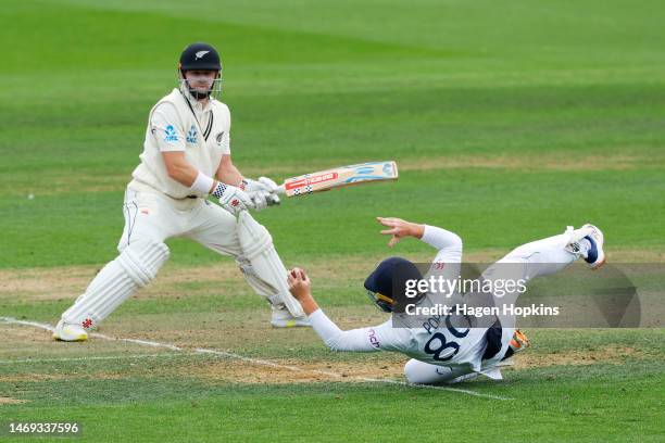 Ollie Pope of England takes a catch to dismiss Henry Nicholls of New Zealand while Ben Foakes celebrates during day two of the Second Test Match...