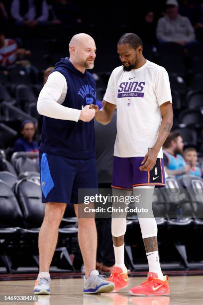 Kevin Durant of the Phoenix Suns greets assistant coach Dave Bliss of the Oklahoma City Thunder before the game at Footprint Center on February 24,...