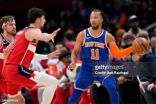Jalen Brunson of the New York Knicks passes as Deni Avdija of the Washington Wizards defends during the second half at Capital One Arena on February...