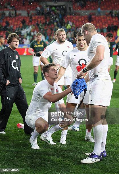 James Haskell commiserates with Owen Farrell of England after Farrell missed with a last kick of the match, drop goal attempt during the third test...