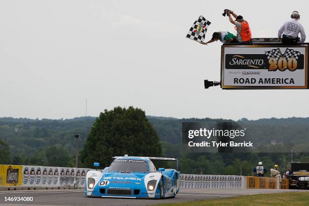 The Chip Ganassi Racing with Felix Sabates BMW Riley, driven by Scott Pruett and Memo Rojas, crosses the finish line to win the Rolex 250 Driven by...