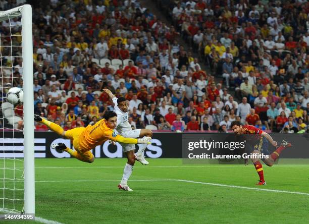 Xabi Alonso of Spain scores the first goal past Hugo Lloris of France during the UEFA EURO 2012 quarter final match between Spain and France at...