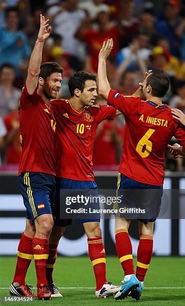 Xabi Alonso of Spain celebrates after scoring the first goal with Cesc Fabregas and Andres Iniesta during the UEFA EURO 2012 quarter final match...