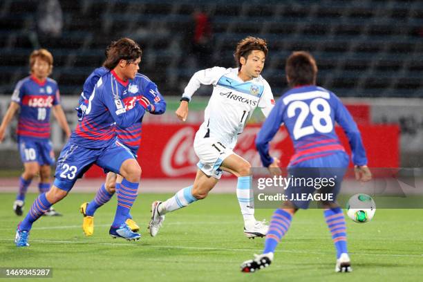 Yu Kobayashi of Kawasaki Frontale controls the ball against Makoto Rindo of Ventforet Kofu during the J.League Yamazaki Nabisco Cup Group A match...