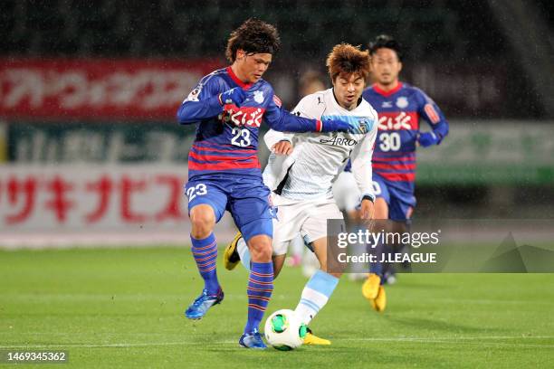 Makoto Rindo of Ventforet Kofu controls the ball against Takuro Yajima of Kawasaki Frontale during the J.League Yamazaki Nabisco Cup Group A match...