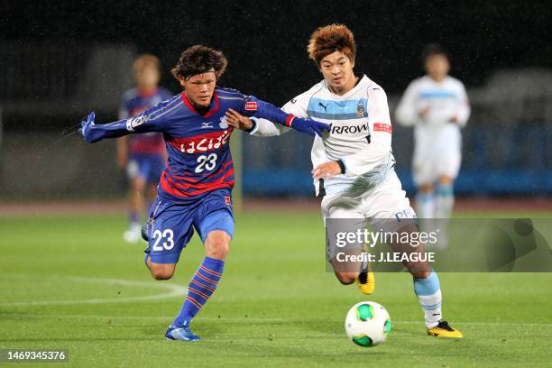 Makoto Rindo of Ventforet Kofu and Takuro Yajima of Kawasaki Frontale compete for the ball during the J.League Yamazaki Nabisco Cup Group A match...