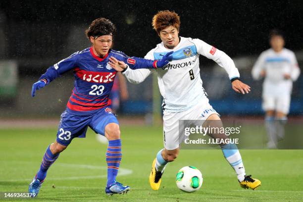 Makoto Rindo of Ventforet Kofu and Takuro Yajima of Kawasaki Frontale compete for the ball during the J.League Yamazaki Nabisco Cup Group A match...