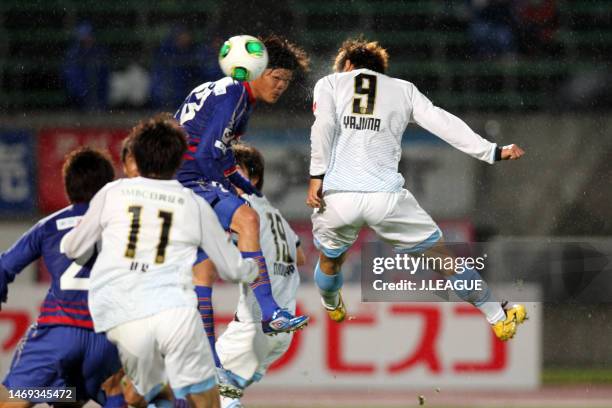 Takuro Yajima of Kawasaki Frontale heads to score the team's first goal during the J.League Yamazaki Nabisco Cup Group A match between Ventforet Kofu...