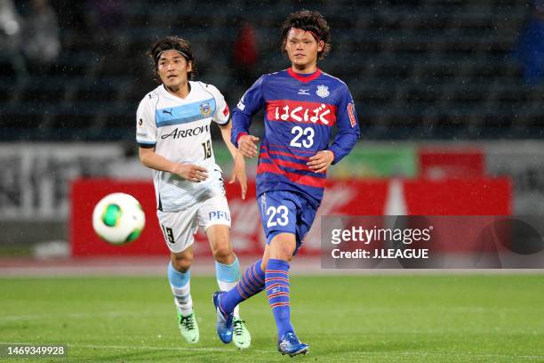 Makoto Rindo of Ventforet Kofu controls the ball against Yoshito Okubo of Kawasaki Frontale during the J.League Yamazaki Nabisco Cup Group A match...