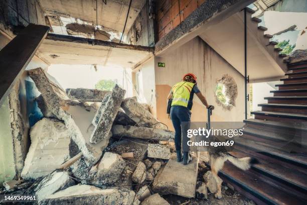 rescuer search trough ruins of building - natural disaster volunteer stock pictures, royalty-free photos & images