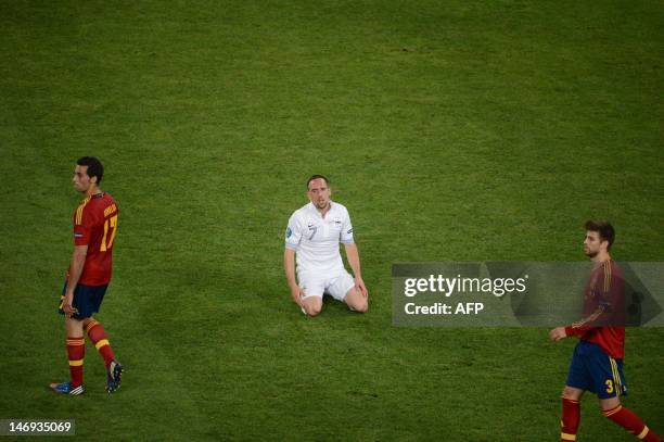French midfielder Franck Ribery reacts next to Spanish defender Alvaro Arbeloa and Spanish defender Gerard Pique during the Euro 2012 football...