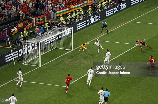 Xabi Alonso of Spain scores the first goal past Hugo Lloris of France during the UEFA EURO 2012 quarter final match between Spain and France at...
