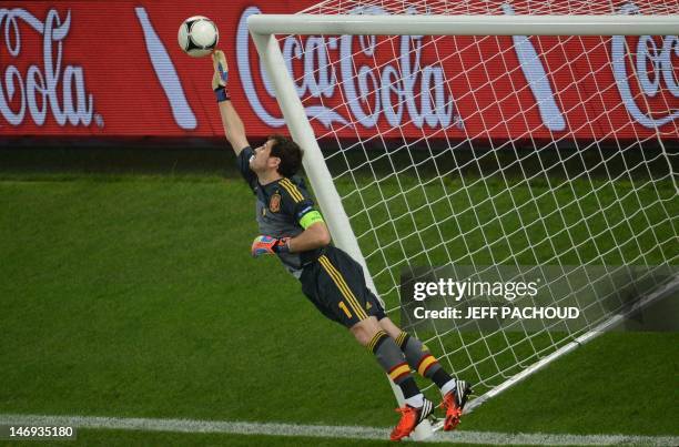 Spanish goalkeeper Iker Casillas jumps to deflect the ball during the Euro 2012 football championships quarter-final match Spain vs France on June...