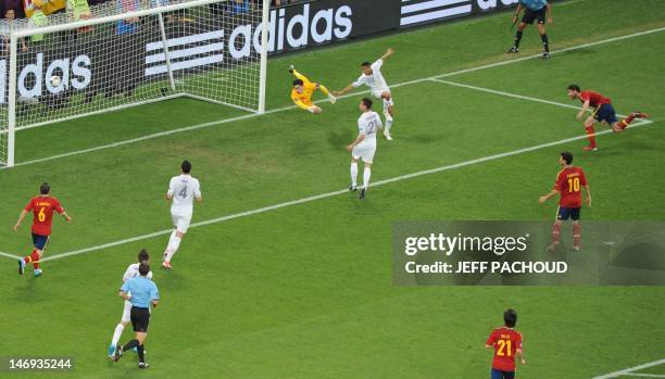 Spanish midfielder Xabi Alonso scores against French goalkeeper Hugo Lloris during the Euro 2012 football championships quarter-final match Spain vs...