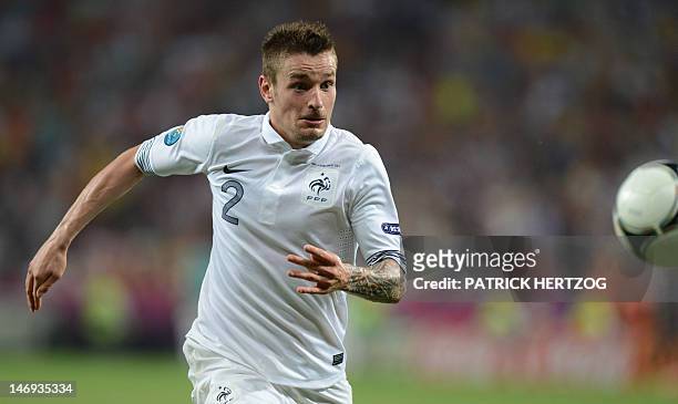 French midfielder Mathieu Debuchy runs after the ball during the Euro 2012 football championships quarter-final match Spain vs France on June 23,...