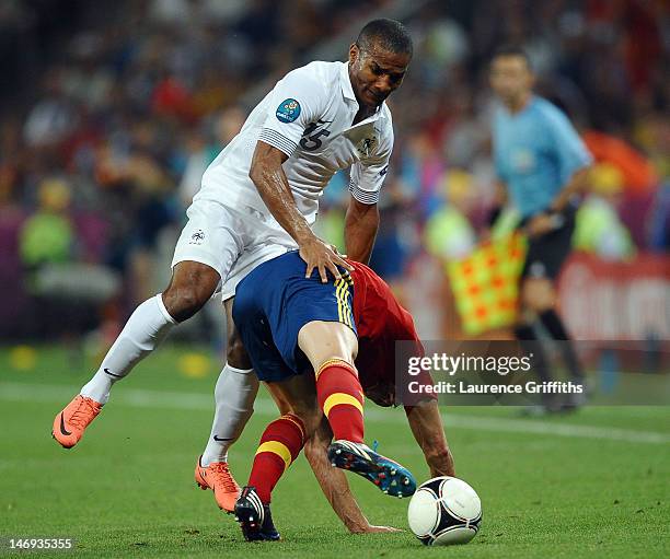Alvaro Arbeloa of Spain and Florent Malouda of France clash during the UEFA EURO 2012 quarter final match between Spain and France at Donbass Arena...