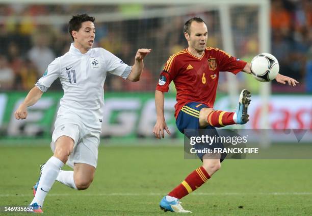 French midfielder Samir Nasri vies with Spanish midfielder Andres Iniesta during the Euro 2012 football championships quarter-final match Spain vs...