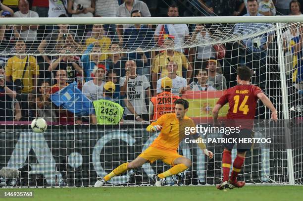 Spanish midfielder Xabi Alonso scores a penalty despite French goalkeeper Hugo Lloris during the Euro 2012 football championships quarter-final match...