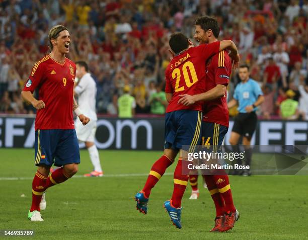 Xabi Alonso of Spain celebrates after scoring the second goal with Santi Cazorla and Fernando Torres during the UEFA EURO 2012 quarter final match...