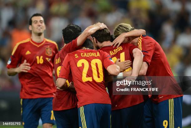 Spanish midfielder Xabi Alonso celebrates with team mate after he scored a goal during the Euro 2012 football championships quarter-final match Spain...