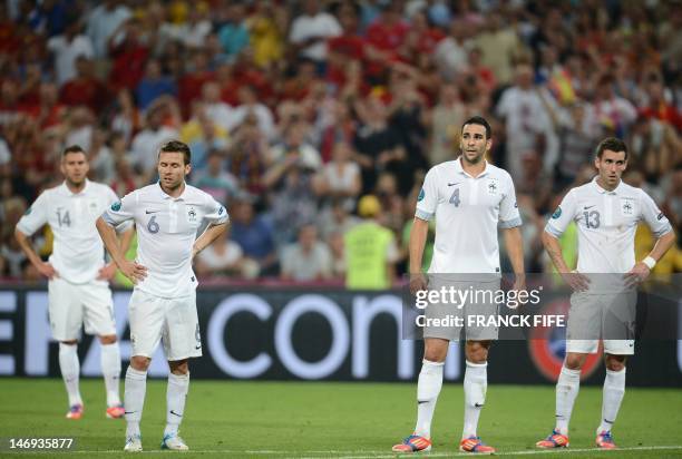 French midfielder Jeremy Menez, midfielder Yohan Cabaye, defender Adil Rami and defender Anthony Reveillere react at the end of the Euro 2012...