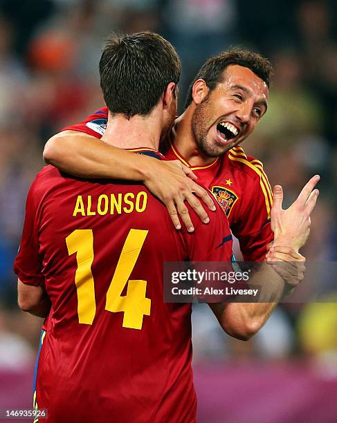 Xabi Alonso of Spain celebrates after scoring the second goal with Santi Cazorla during the UEFA EURO 2012 quarter final match between Spain and...