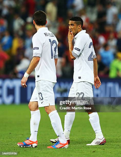 Anthony Reveillere and Gael Clichy of France look dejected after defeat during the UEFA EURO 2012 quarter final match between Spain and France at...