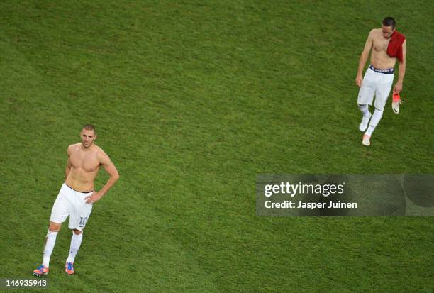 Karim Benzema and Franck Ribery of France look dejected after defeat during the UEFA EURO 2012 quarter final match between Spain and France at...