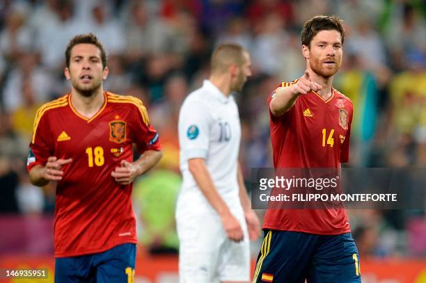 Spanish midfielder Xabi Alonso and Spanish defender Jordi Alba celebarte at the end of the Euro 2012 football championships quarter-final match Spain...