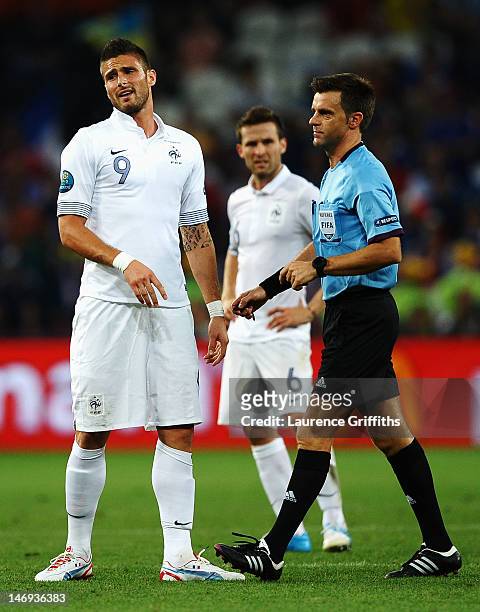 Olivier Giroud of France reacts as referee Nicola Rizzoli looks on during the UEFA EURO 2012 quarter final match between Spain and France at Donbass...