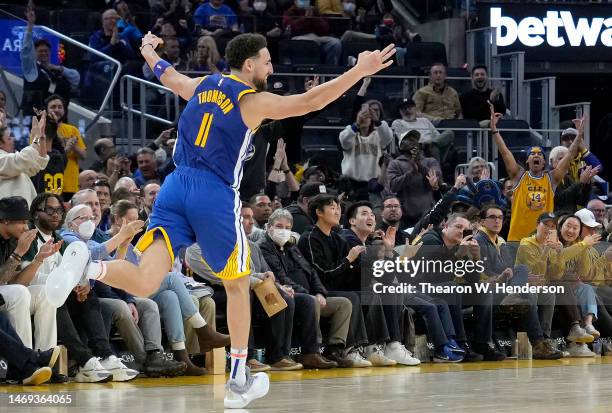 Klay Thompson of the Golden State Warriors reacts after making a three-point shot against the Houston Rockets during the fourth quarter at Chase...