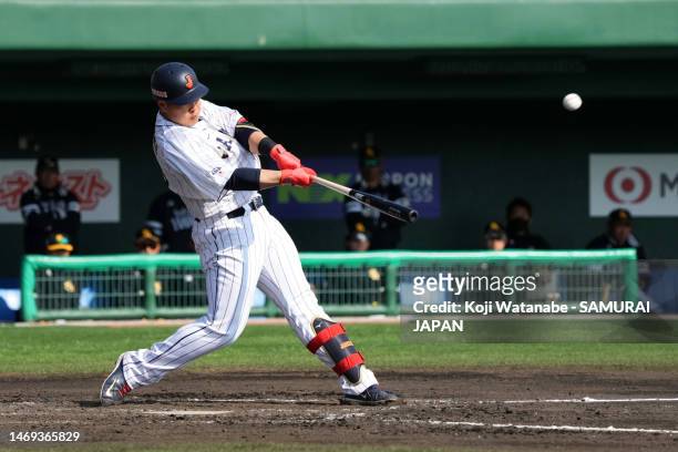 Infielder Kazuma Okamoto of Samurai Japan hits a two-run double in the fourth inning during the practice game between Samurai Japan and Fukuoka...