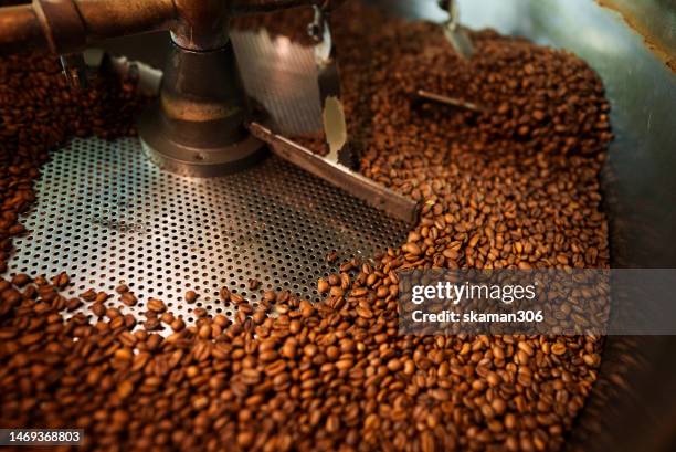 close up slow motion cooling batch spinning   roasted coffee beans with a roasting machine - coffee slow motion stock pictures, royalty-free photos & images