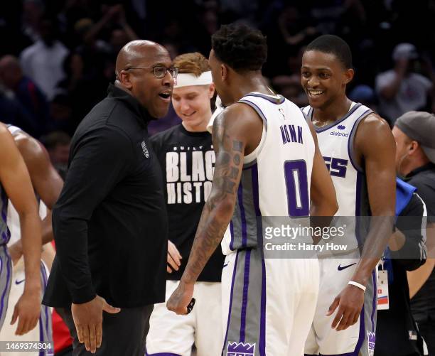 Head coach Mike Brown of the Sacramento Kings celebrates a 176-175 double overtime win over the LA Clippers with Malik Monk and De'Aaron Fox at...