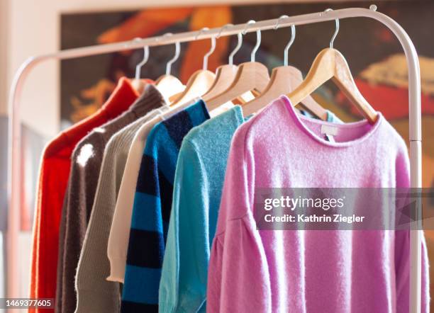clothes rail with colorful cashmere sweaters - coathanger stock pictures, royalty-free photos & images