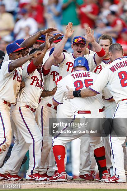 Jim Thome of the Philadelphia Phillies puts his foot on home plate after hitting a home run in the bottom of the ninth inning to win the game against...