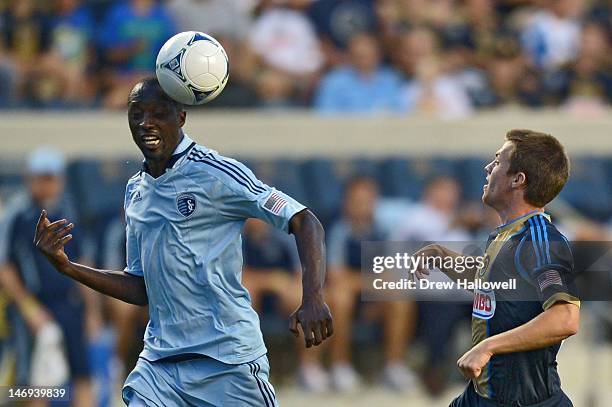 Lawrence Olum of the Sporting Kansas City heads the ball past Antoine Hoppenot of the Philadelphia Union at PPL Park on June 23, 2012 in Chester,...