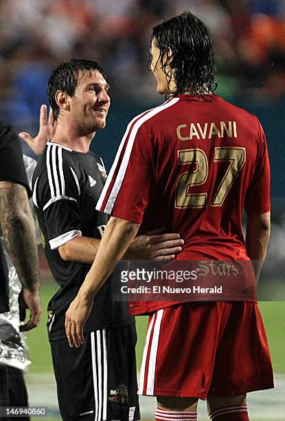 Lionel Messi, left, and Edinson Cavani greet each other at the end of the match between the Red Stars and the Black Masters in The World Soccer...