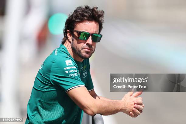 Fernando Alonso of Spain and Aston Martin F1 Team looks on in the Pitlane during day three of F1 Testing at Bahrain International Circuit on February...