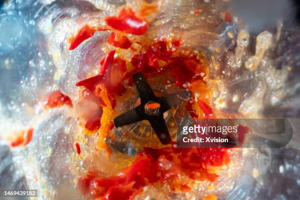 red chili under high speed blending synced in high speed photography - mixer stock-fotos und bilder