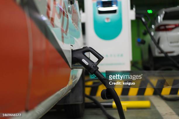 charging electric car close-up - fuel efficiency stock pictures, royalty-free photos & images