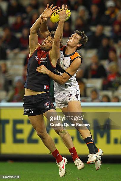 Jared Rivers of the Demons marks infront of Phil Davis of the Giants during the round 13 AFL match between the Melbourne Demons and the Greater...