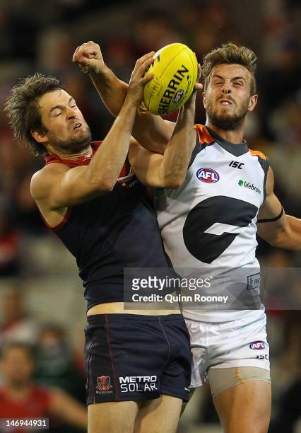 Jared Rivers of the Demons marks infront of Tim Mohr of the Giants during the round 13 AFL match between the Melbourne Demons and the Greater Western...