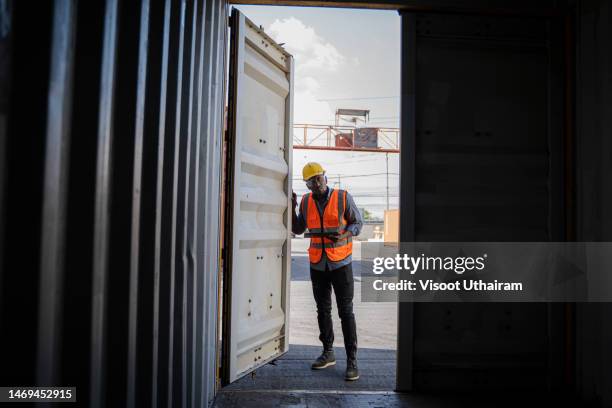 supervisor checking containers data at container yard. - commercial dock stockfoto's en -beelden