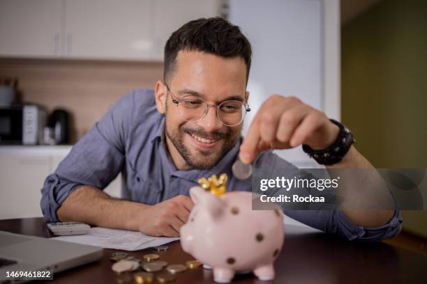 young woman using calculator while going through bills and home finances - caixa de dinheiro acessório financeiro imagens e fotografias de stock